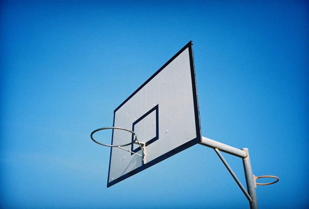 white basketball hoop under blue sky during daytime