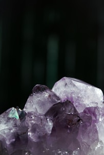 Close-up of a vibrant amethyst cluster sparkling under natural light, showcasing its deep purple hues and crystal formations.