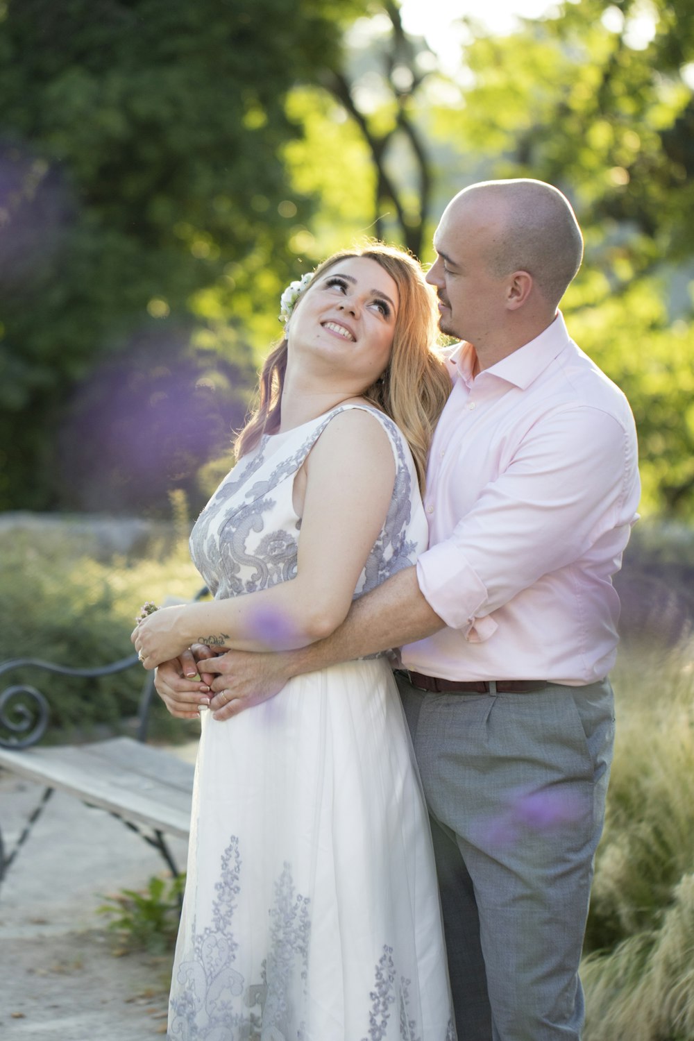 man in white dress shirt kissing woman in white dress