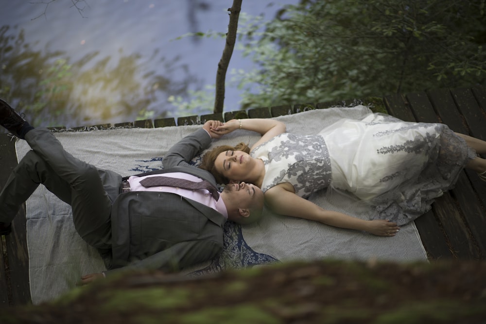 woman in white and black floral dress lying on gray hammock