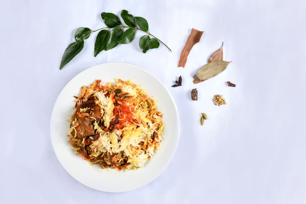 white ceramic plate with rice and green leaves