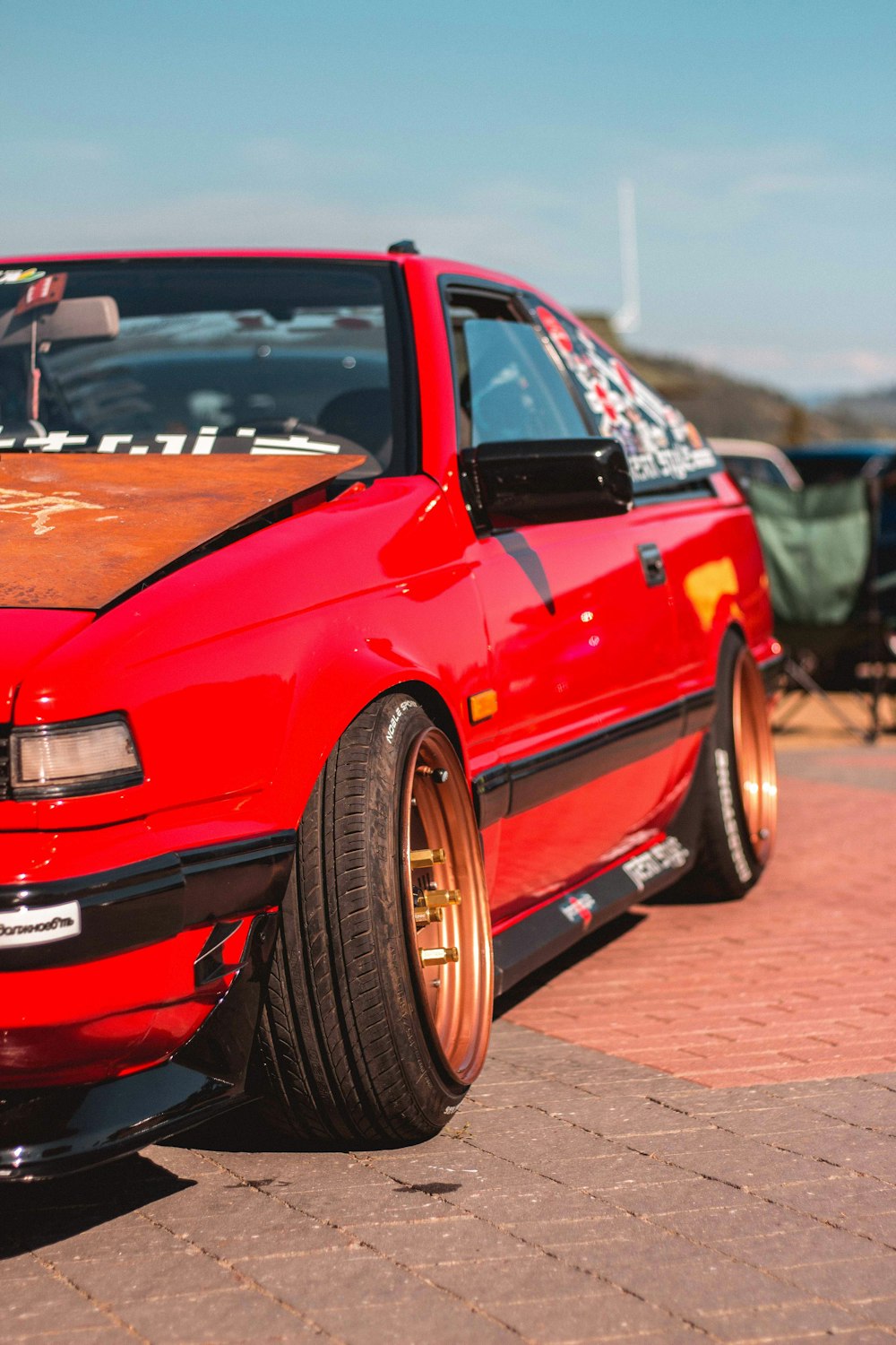 red bmw m 3 coupe parked on gray concrete pavement during daytime