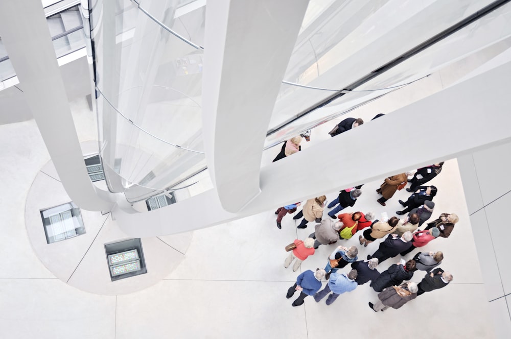 people sitting on white tiled floor