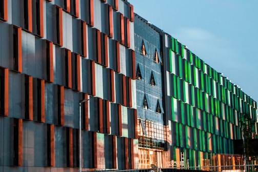 Contemporary commercial building with glass facade and orange accents