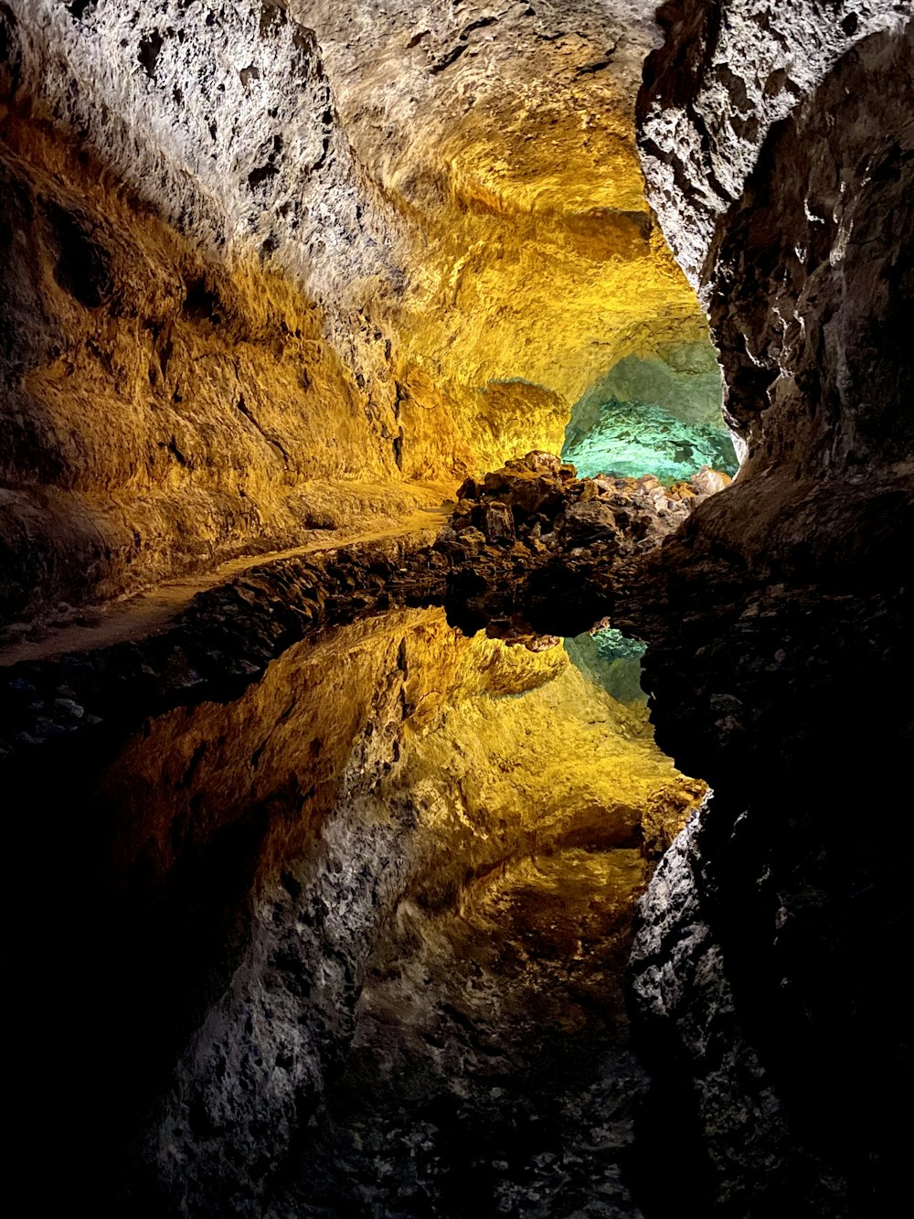 brown and yellow cave with water