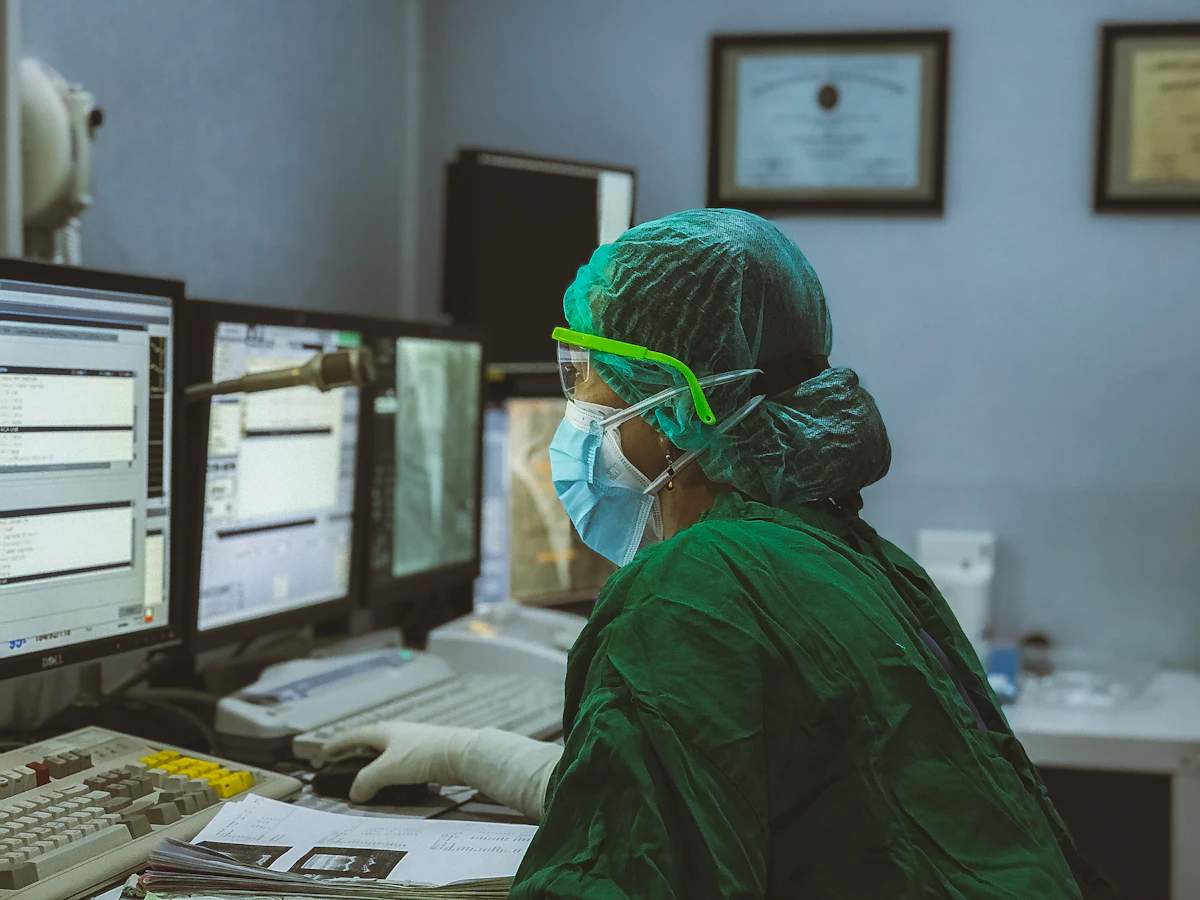 Billing specialist working claims across multiple monitors