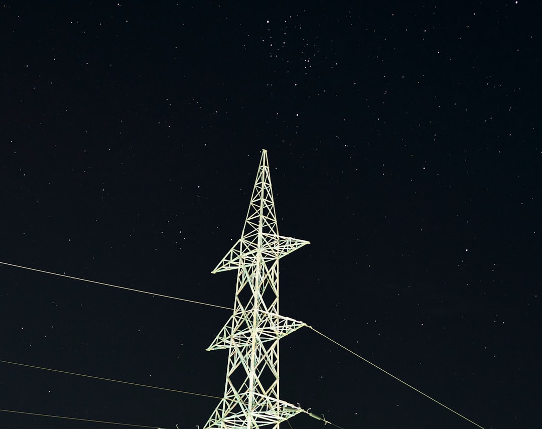 white and black electric tower during night time