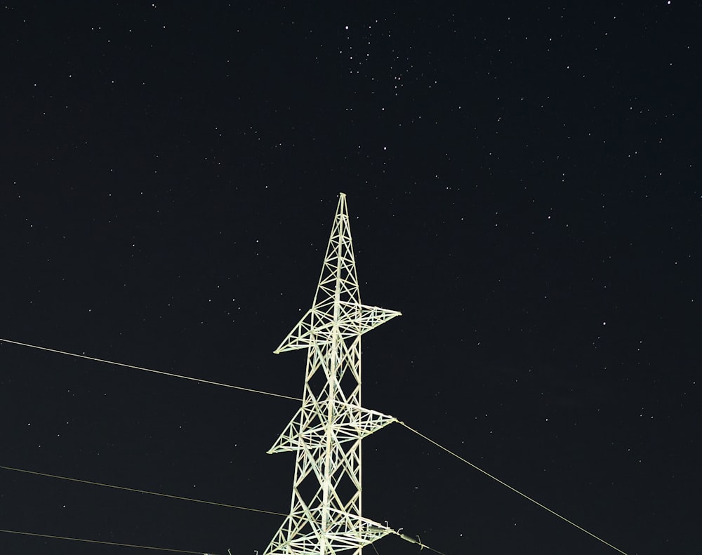white and black electric tower during night time