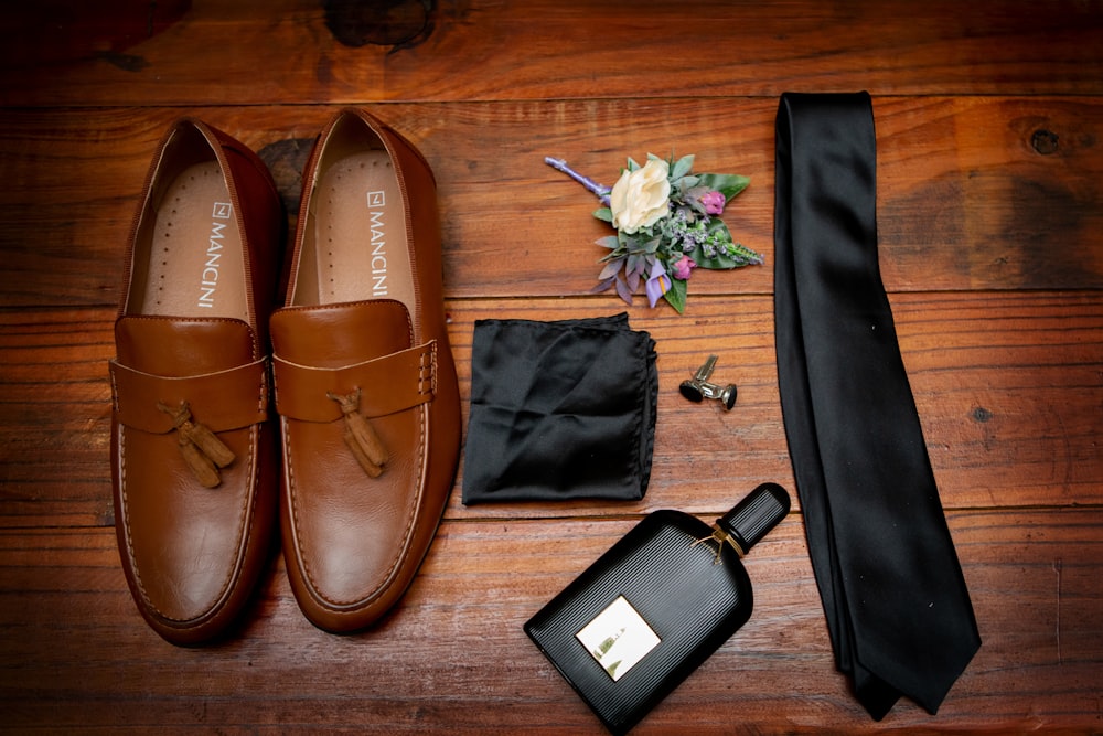 brown leather boat shoes beside black leather wallet