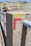Close-up of a sturdy concrete post installed outdoors on a sunny day.