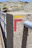 Close-up of a sturdy concrete post installed outdoors on a sunny day.