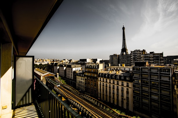 Chic apartment balcony overlooking Paris skyline at sunset
