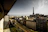 Happy traveler enjoying a sunny balcony view in Paris.