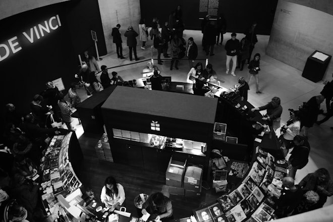 people in a restaurant in a grayscale photography
