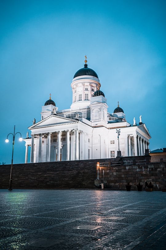 white and blue concrete building near body of water during daytime in Helsinki Cathedral Finland