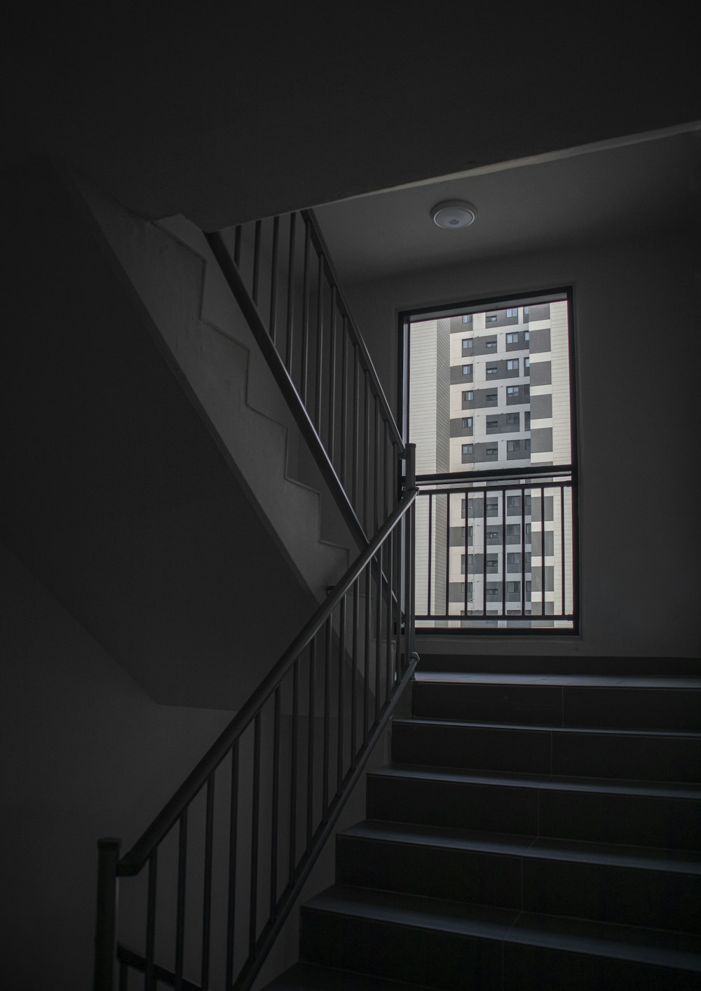 white and black staircase with white wooden railings