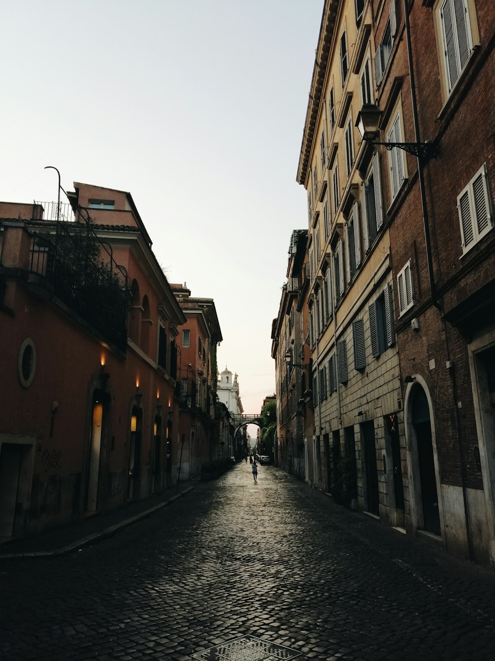 people walking on street between buildings during daytime