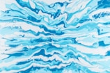 Custom epoxy floor design blending blue and white swirls in a modern home.