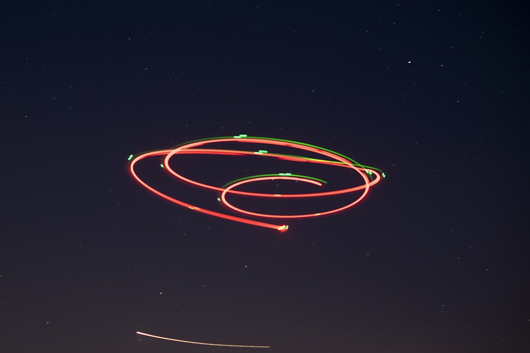 red and yellow light streaks, Long exposure photo of a drone.