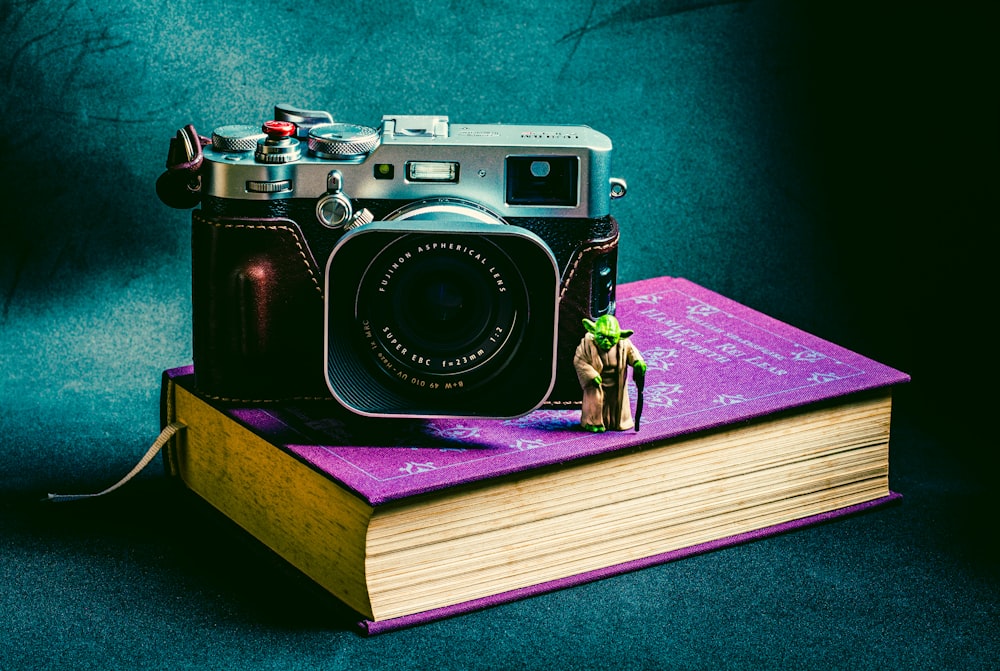 black and silver camera on brown wooden table