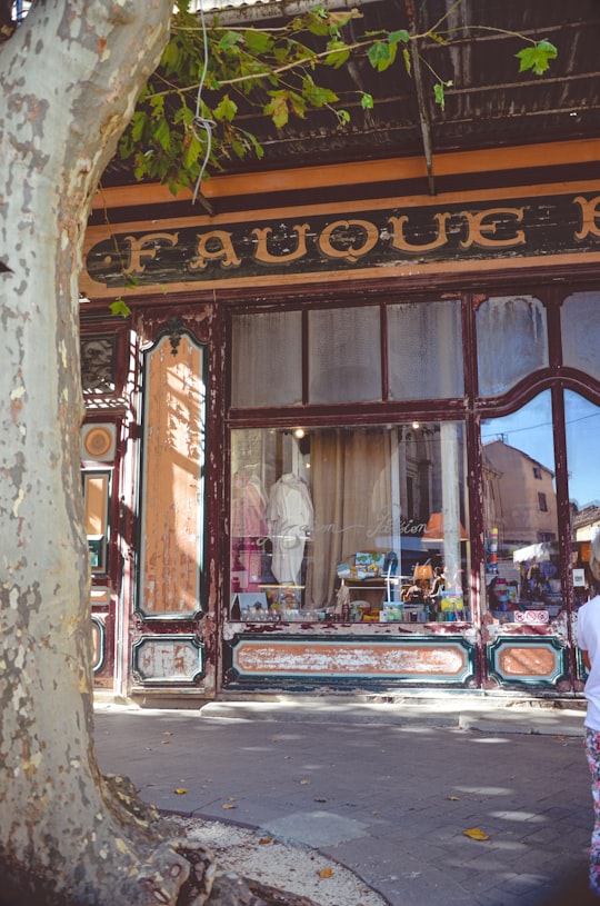 brown wooden store with people in store in L'Isle-sur-la-Sorgue France