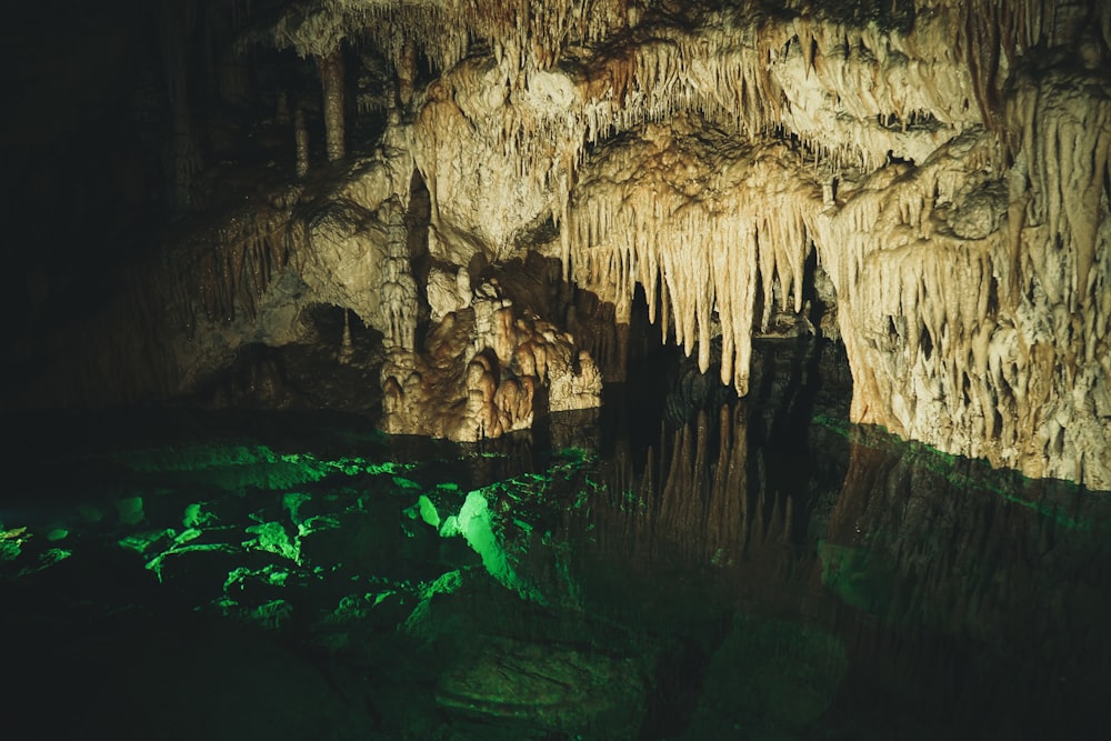 brown rock formation with green water