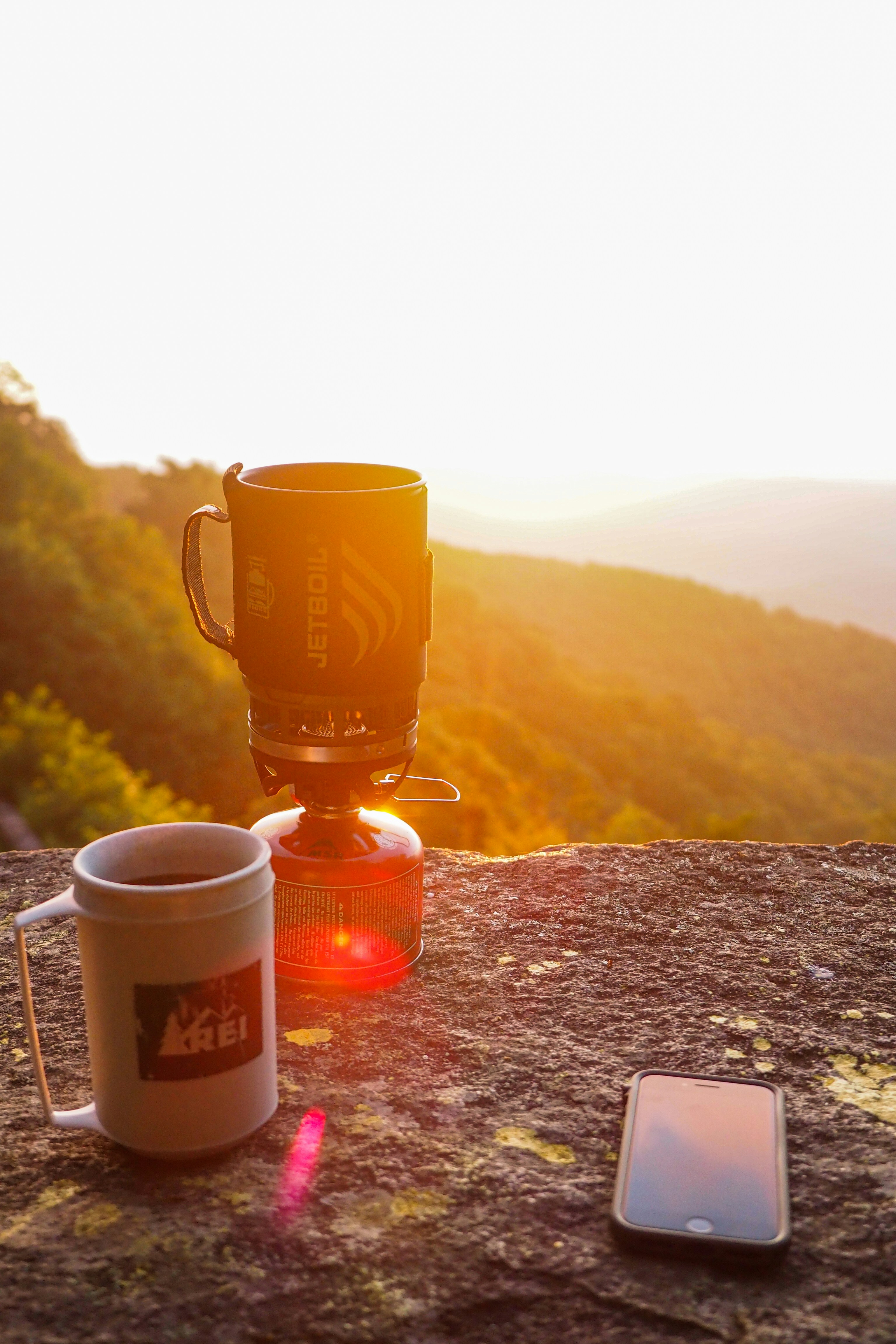 brown ceramic mug on brown rock
