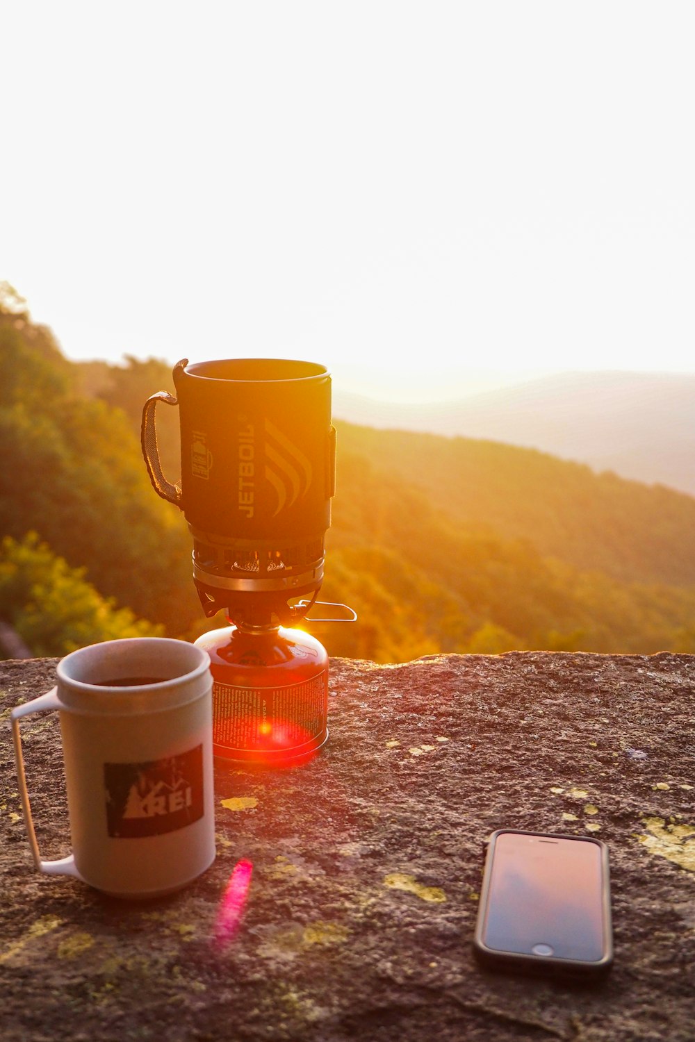 brown ceramic mug on brown rock