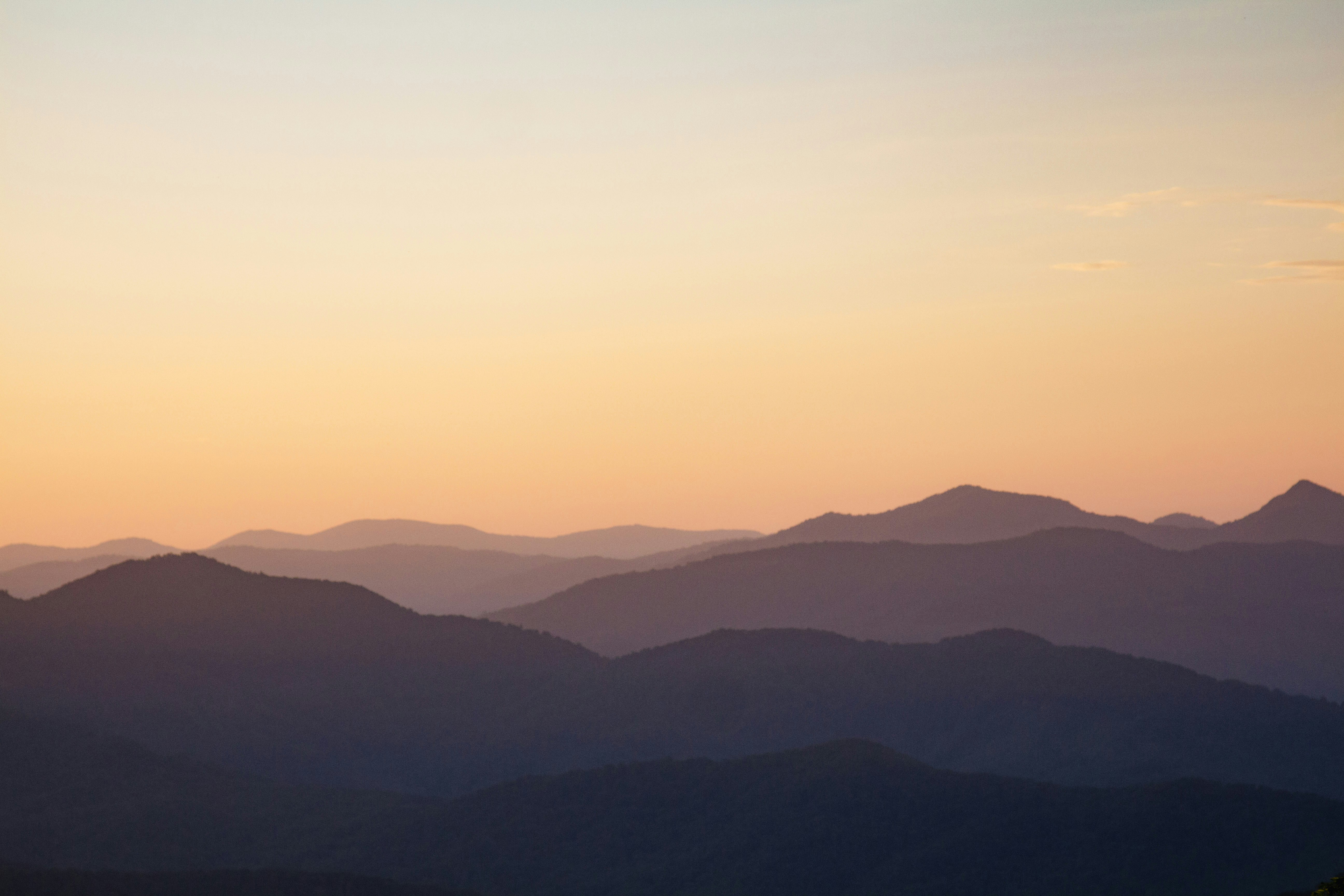 silhouette of mountains during sunset, layers