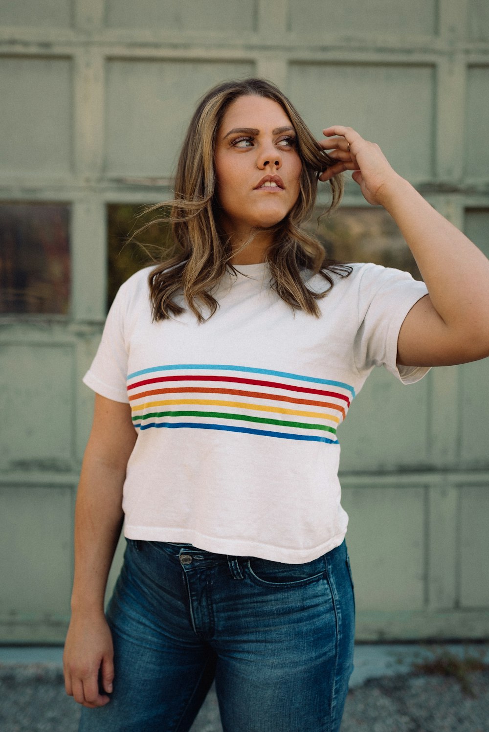 woman in white red and blue striped t-shirt and blue denim bottoms