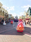 woman in pink dress walking on street during daytime