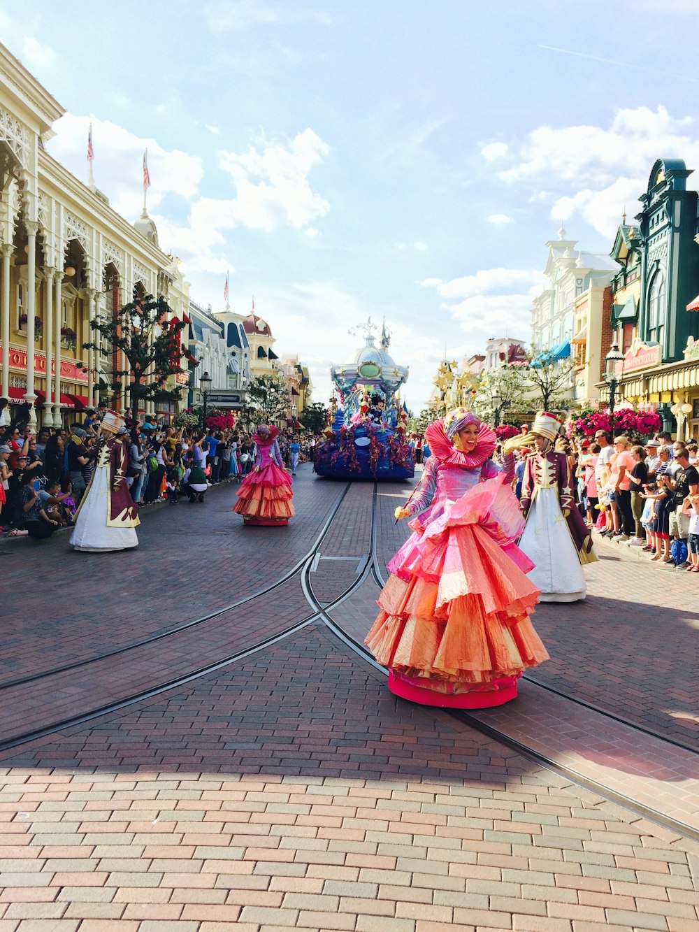 woman in pink dress walking on street during daytime