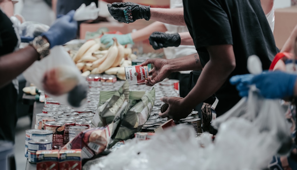 man in black t-shirt holding coca cola bottle