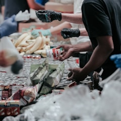 man in black t-shirt holding coca cola bottle