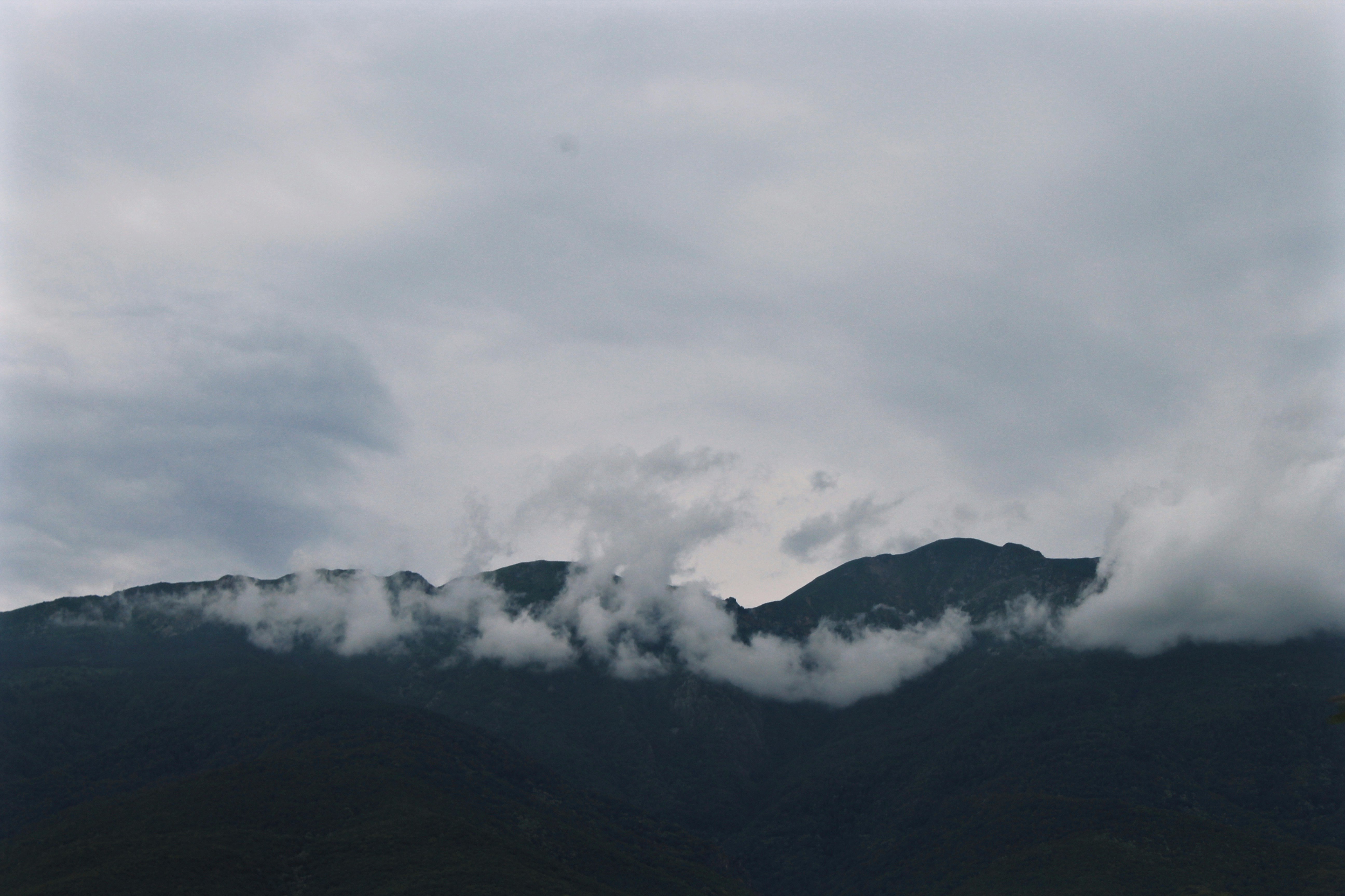 black mountain under white clouds