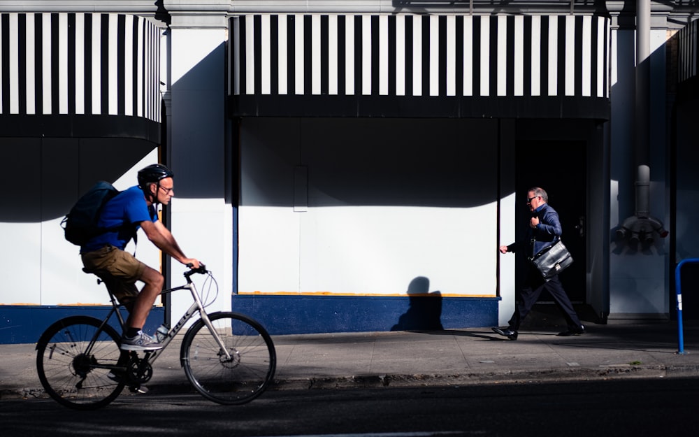 man in blue t-shirt riding on bicycle