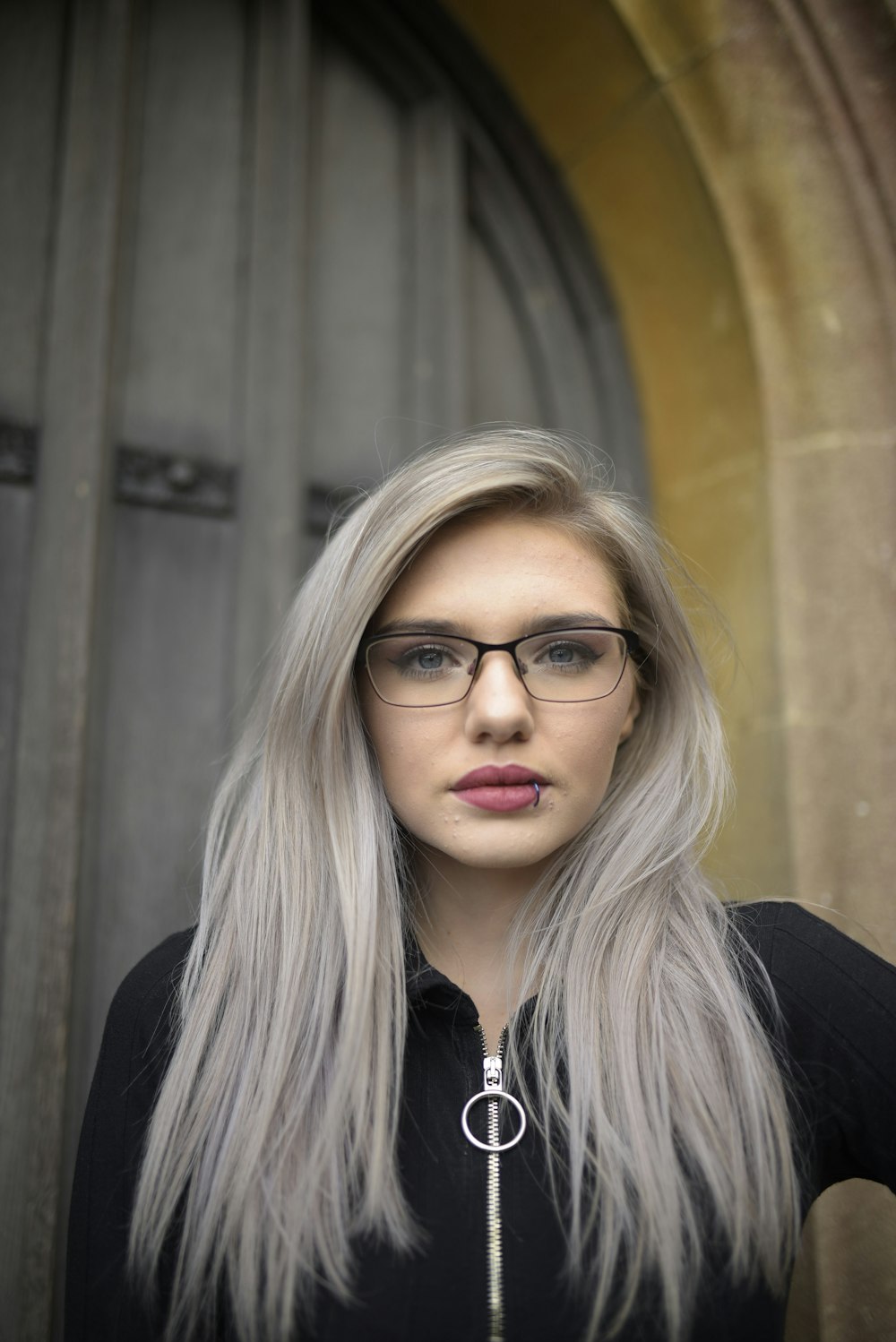 woman in black blazer wearing eyeglasses