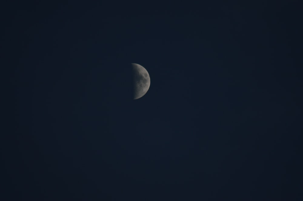 white moon in dark night sky