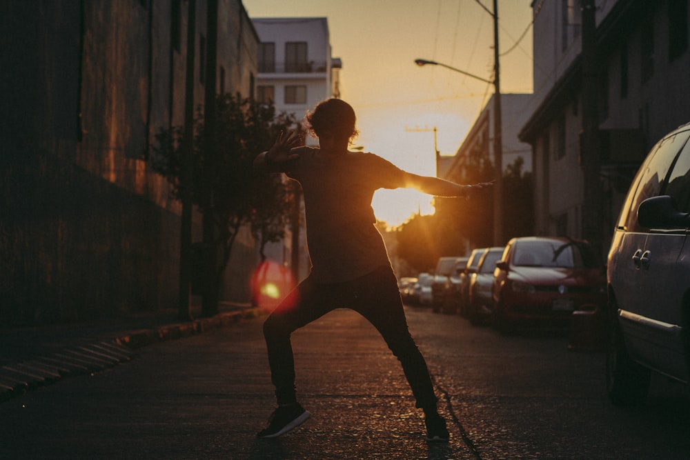 man in black pants and black shoes running on street during daytime