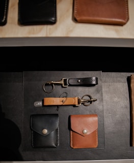 brown leather wallet on black textile