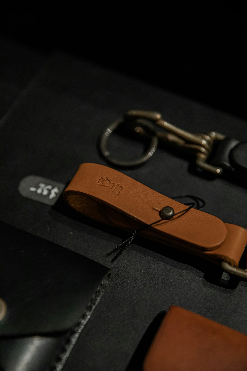 gold key on black leather textile