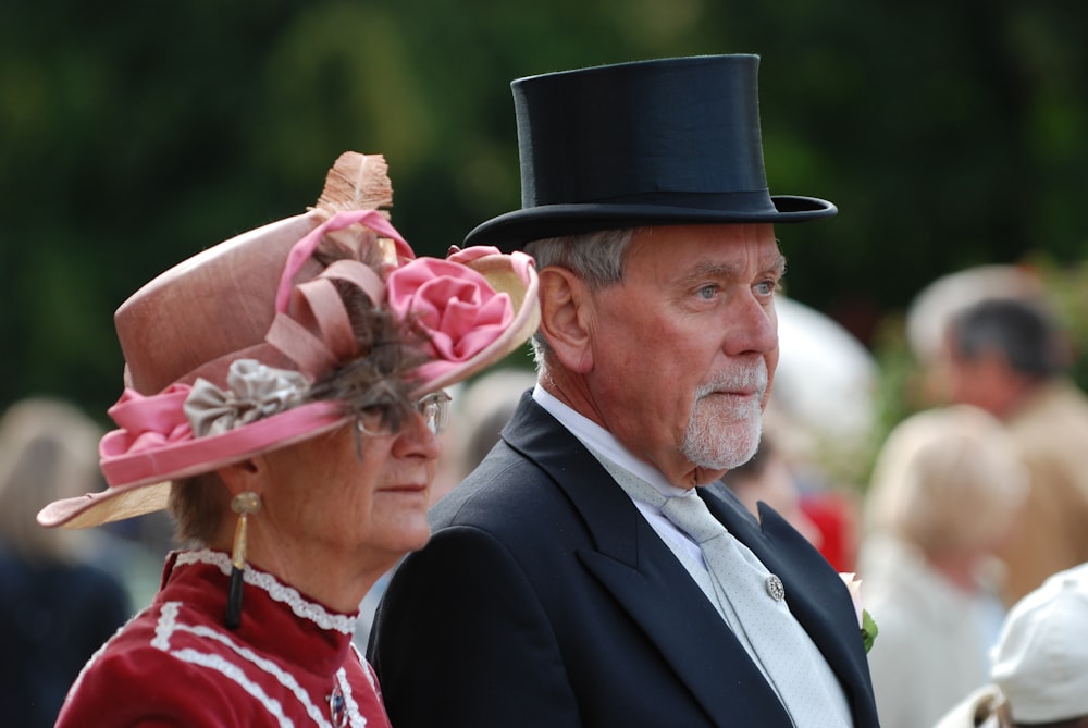 man in black suit jacket and woman in red dress