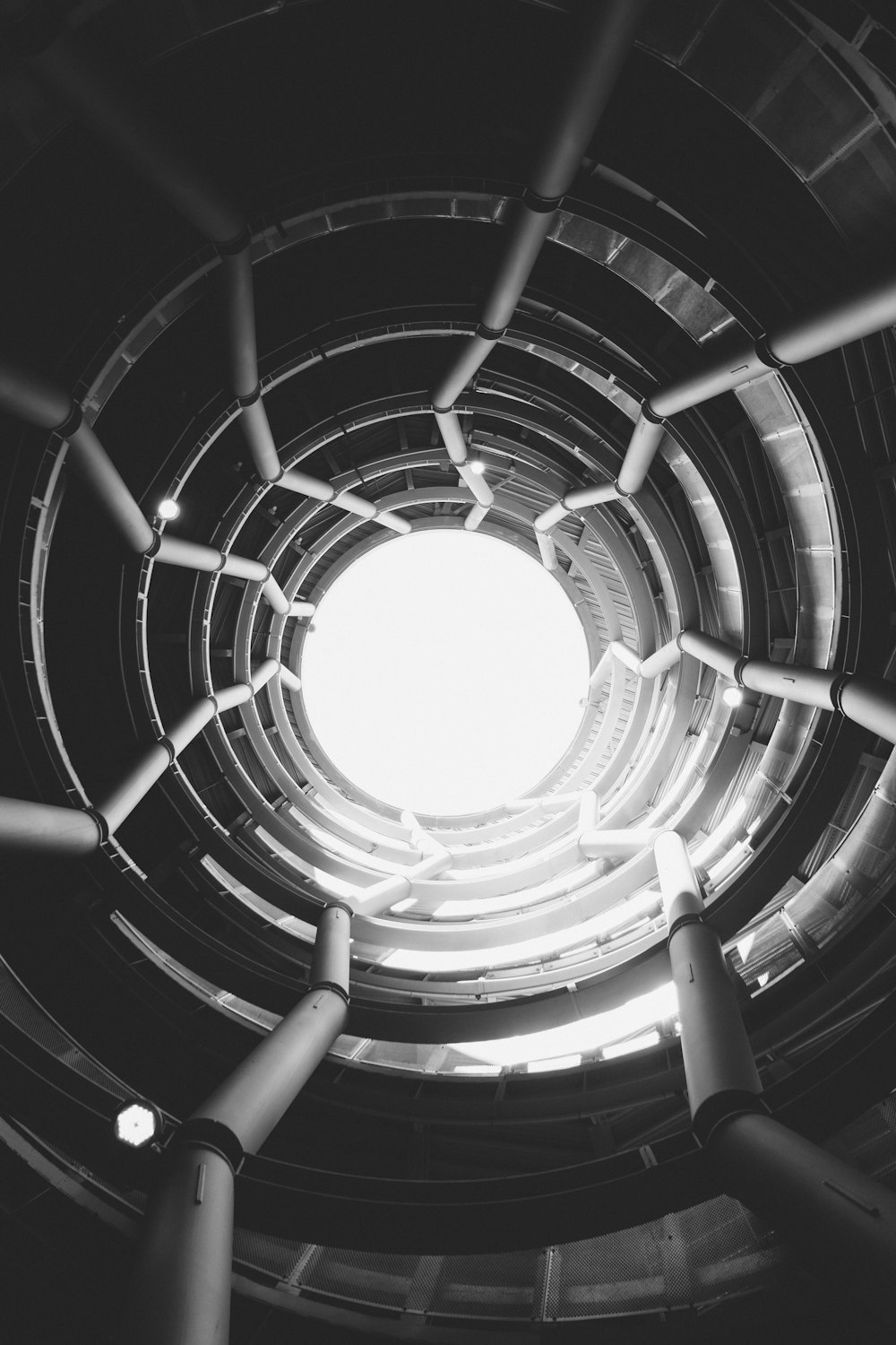 black spiral staircase with white round ceiling