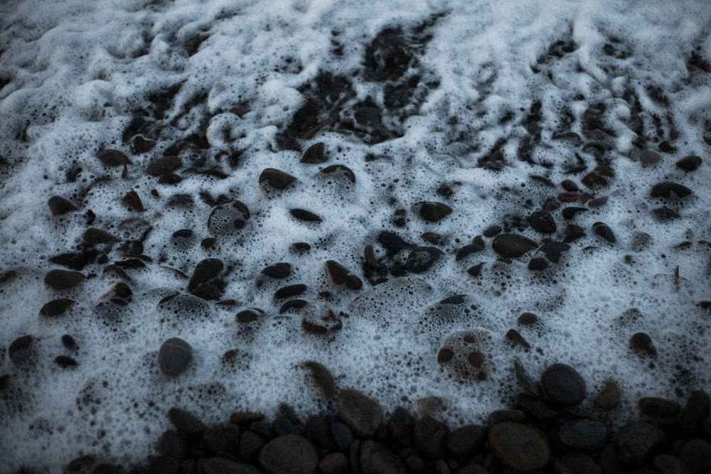 white snow on black sand