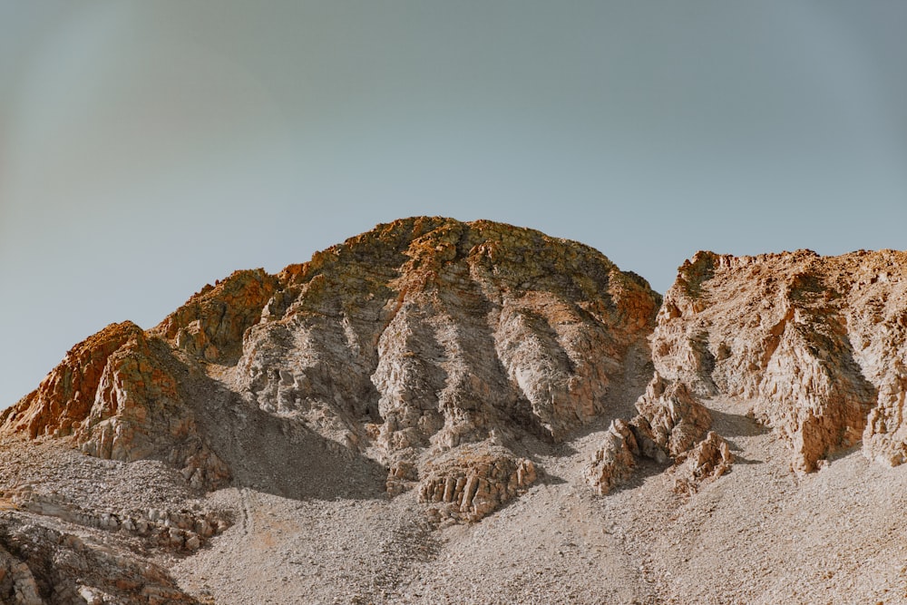 brown rocky mountain under blue sky during daytime