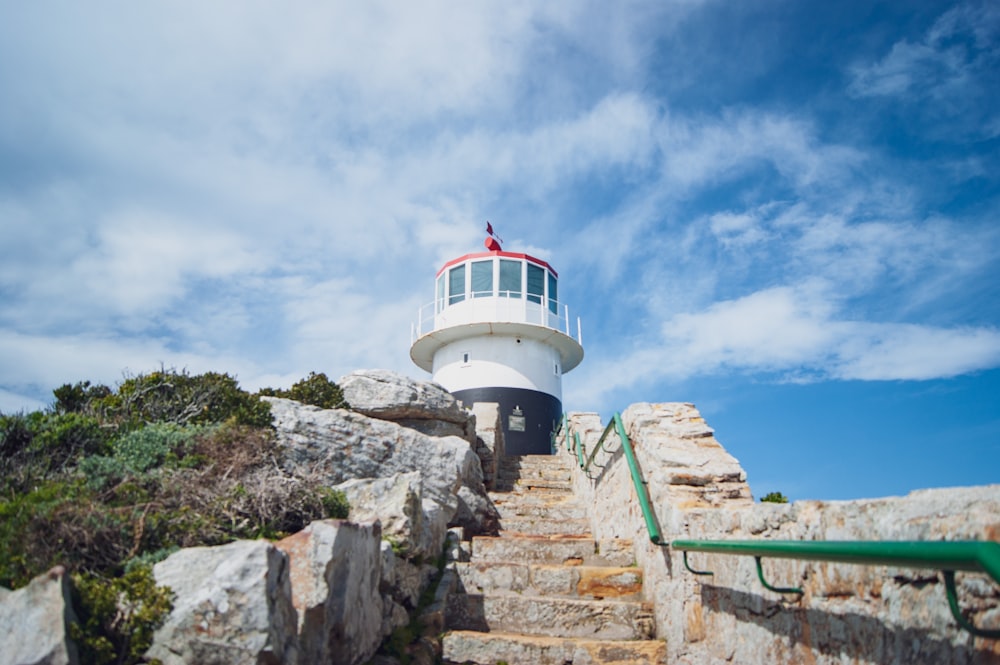 white and red lighthouse under blue sky