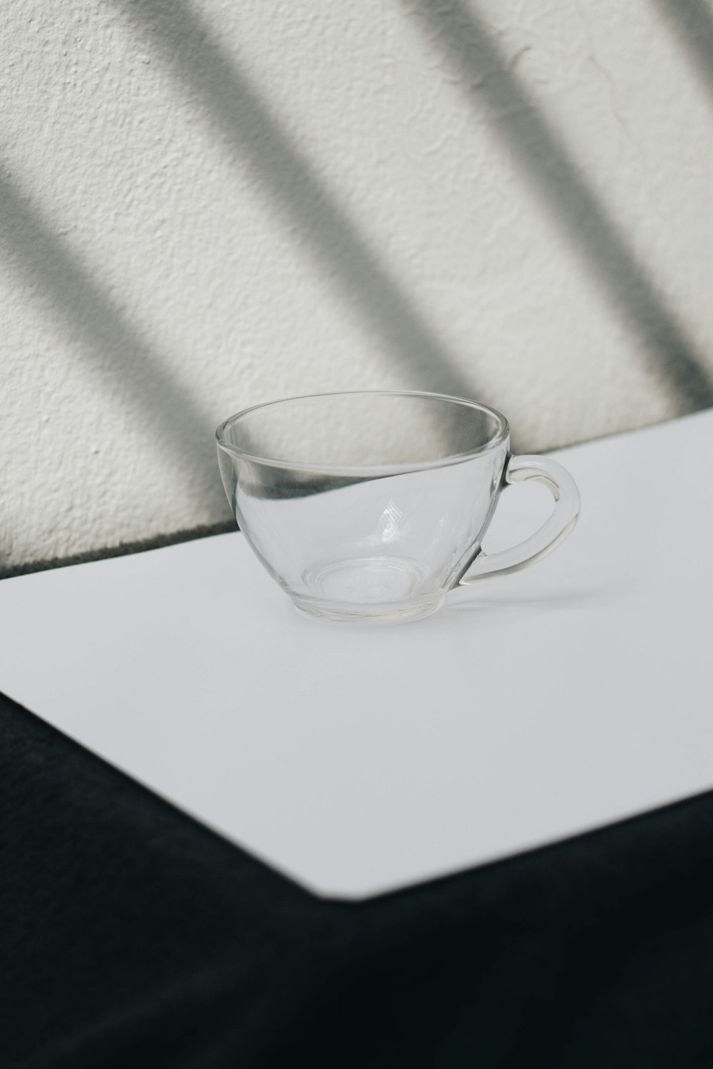 clear glass cup on white table