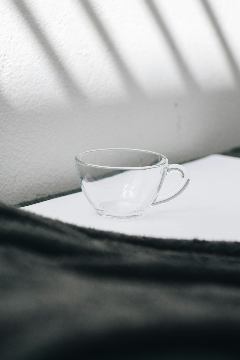 clear glass mug on white table