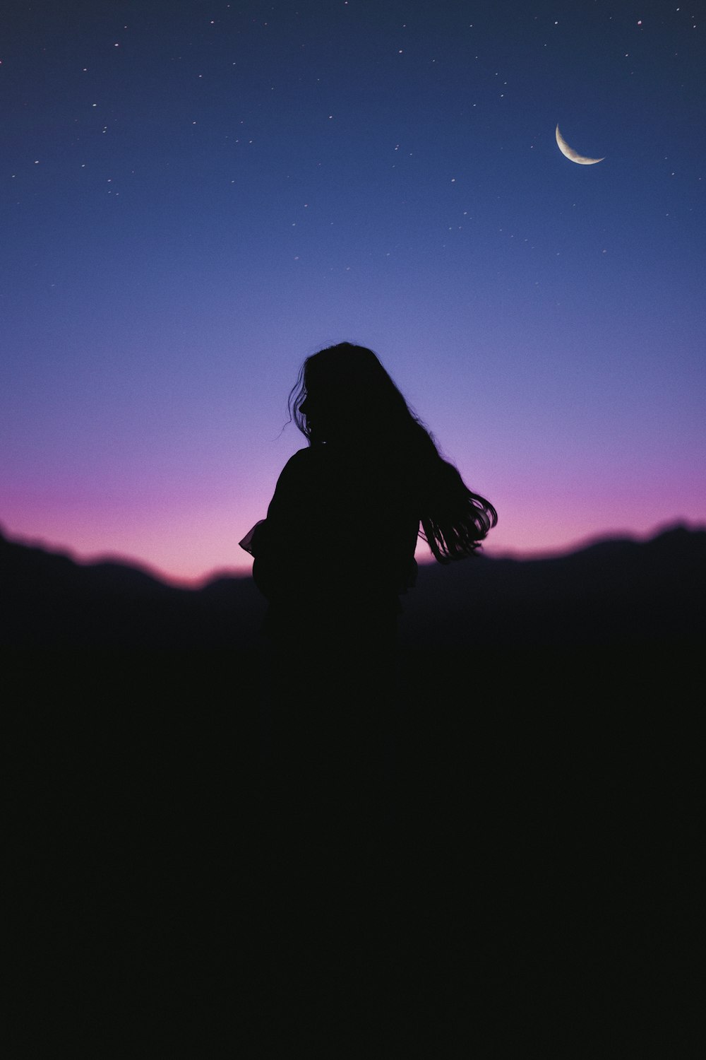 silhouette of woman during night time