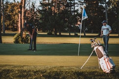 man in black shirt and black pants playing golf during daytime